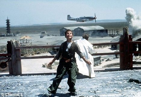 Christian Bale's character with a P-51 behind him